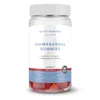 Transparante pot met witte deksel, gevuld met rode gummies.