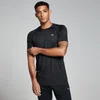 Een man draagt een zwart trainingsshirt met korte mouwen en een klein wit logo.