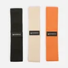 Drie elastische banden in zwart, beige en oranje met het Myprotein logo.