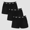 Drie zwarte boxershorts met een witte band met logo, gestapeld op elkaar.