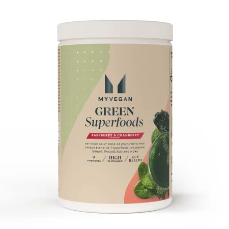 Een witte pot met een etiket voor Myvegan Green Superfood Blend, framboos en cranberry.