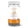 Een doorzichtige pot met witte deksel, gevuld met donkerpaarse gummies.